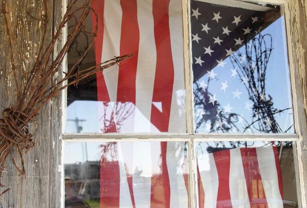 OR, Shaniko Flag in window next to barbed wire